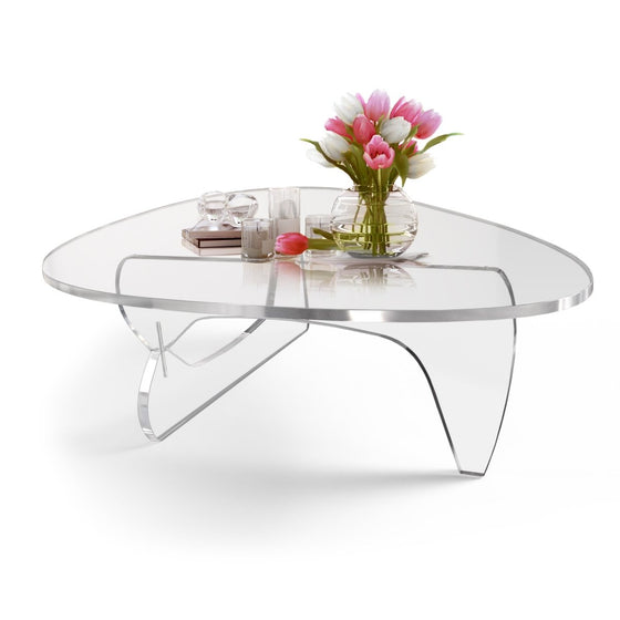 Noguchi style clear acrylic table with flowers and decorations on top. 