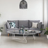 Noguchi clear acrylic table in a nice livingroom with a gray sofa and light color flooring.
