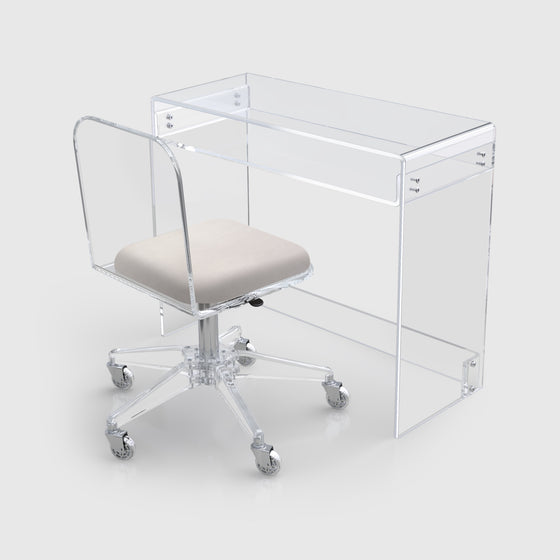 Clear acrylic chair from stauber furnishings with cream microsuede cushion with clear acrylic waterfall desk.